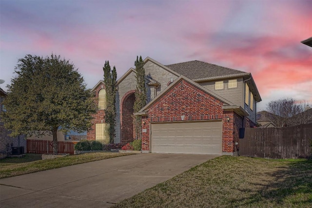 1003 Preserve Pl, Round Rock, TX 78665 - traditional home featuring concrete driveway, an attached garage, central air condition unit, and stone siding