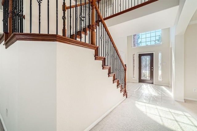 1003 Preserve Pl, Round Rock, TX 78665 - carpeted foyer entrance with baseboards, stairway, and a towering ceiling