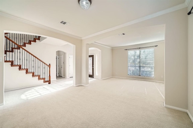 1003 Preserve Pl, Round Rock, TX 78665 - unfurnished room featuring arched walkways, ornamental molding, light carpet, baseboards, and stairs