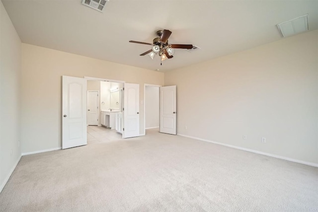 1003 Preserve Pl, Round Rock, TX 78665 - unfurnished bedroom with light colored carpet, baseboards, connected bathroom, and a ceiling fan