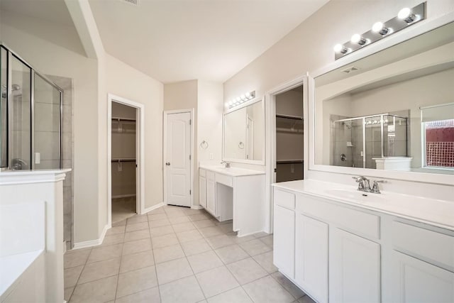 1003 Preserve Pl, Round Rock, TX 78665 - full bathroom featuring a stall shower, a spacious closet, two vanities, and tile patterned flooring
