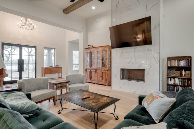 521 Wonderstruck, Liberty Hill, TX 78642 - living area featuring a premium fireplace, a high ceiling, a chandelier, recessed lighting, and light wood-style flooring
