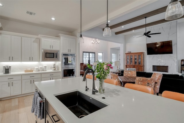 521 Wonderstruck, Liberty Hill, TX 78642 - kitchen featuring appliances with stainless steel finishes, recessed lighting, open floor plan, backsplash, and white cabinets