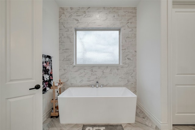 521 Wonderstruck, Liberty Hill, TX 78642 - bathroom featuring a freestanding bath and baseboards