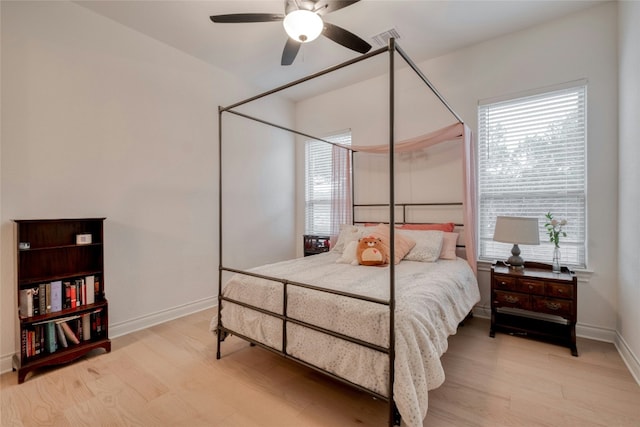 521 Wonderstruck, Liberty Hill, TX 78642 - bedroom featuring multiple windows, wood finished floors, and ceiling fan