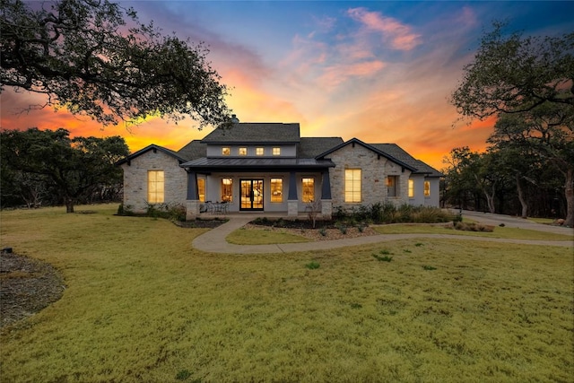 521 Wonderstruck, Liberty Hill, TX 78642 - view of front facade with stone siding, a standing seam roof, a front yard, and a metal roof