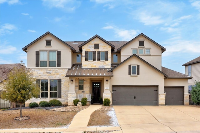 view of front of property with stone siding, a standing seam roof, and driveway