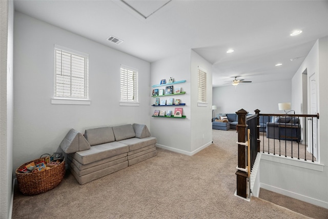 living room with recessed lighting, light colored carpet, visible vents, a ceiling fan, and baseboards