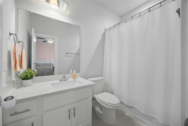 full bath with shower / tub combo with curtain, vanity, toilet, and tile patterned floors