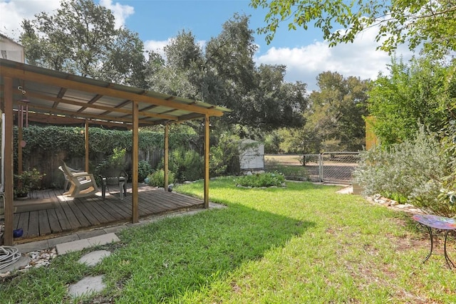 view of yard featuring a fenced backyard, an outbuilding, a storage unit, a wooden deck, and a pergola