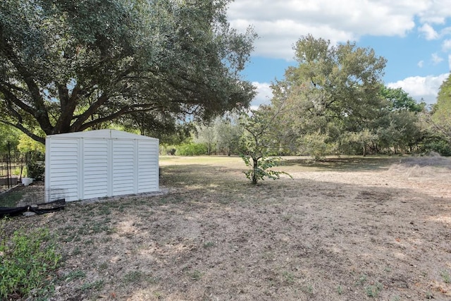 view of yard with an outdoor structure and a shed