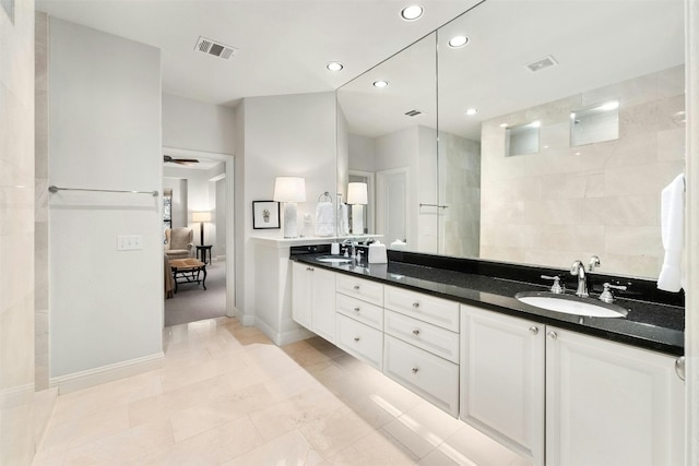 full bath featuring ensuite bathroom, double vanity, a sink, and visible vents