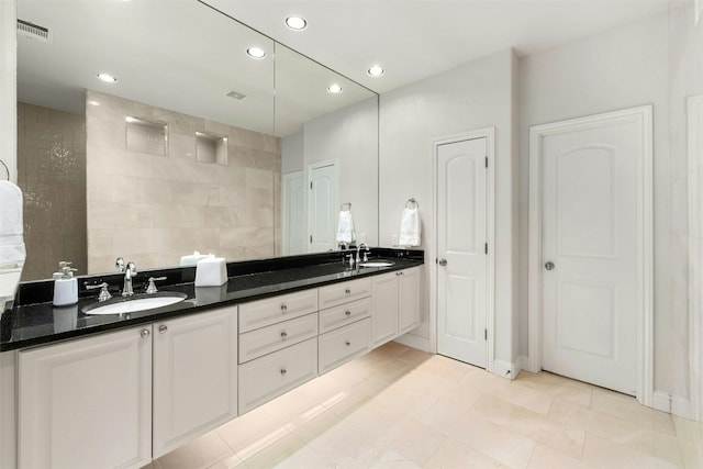 bathroom featuring double vanity, a sink, visible vents, and recessed lighting