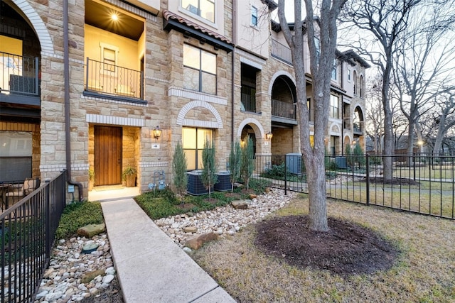 exterior space with stone siding and fence