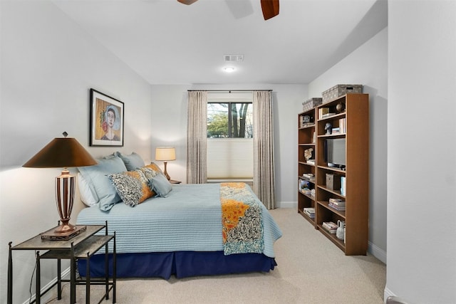 carpeted bedroom featuring a ceiling fan, visible vents, and baseboards