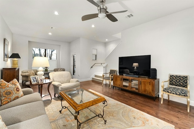 living room featuring dark wood-style flooring, recessed lighting, visible vents, stairway, and baseboards