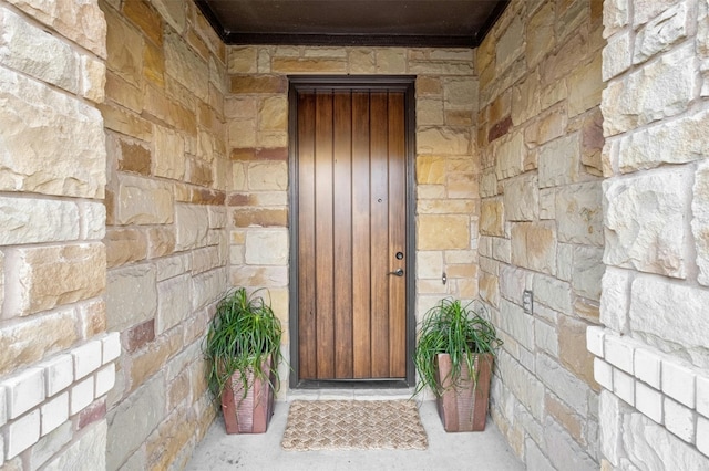 entrance to property with stone siding