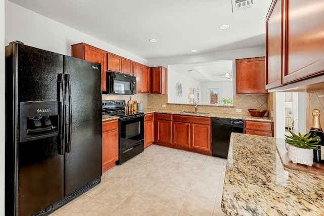 508 Sheldon Lake Dr, Georgetown, TX 78633 - kitchen featuring black appliances, backsplash, light stone counters, a sink, and recessed lighting