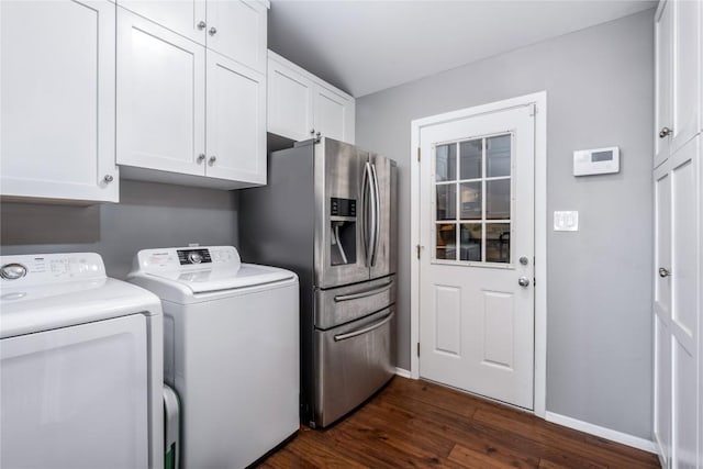 washroom featuring cabinet space, washing machine and dryer, baseboards, and dark wood-style flooring