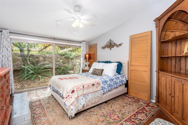 bedroom featuring a ceiling fan, vaulted ceiling, and wood finished floors