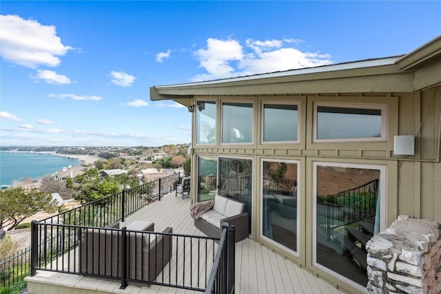 wooden terrace featuring a water view