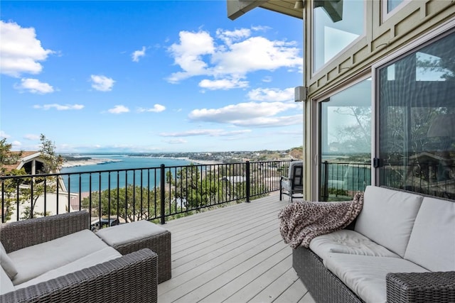 wooden terrace featuring a water view and an outdoor living space