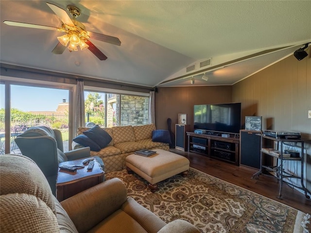 living area with visible vents, ceiling fan, vaulted ceiling, a textured ceiling, and wood finished floors
