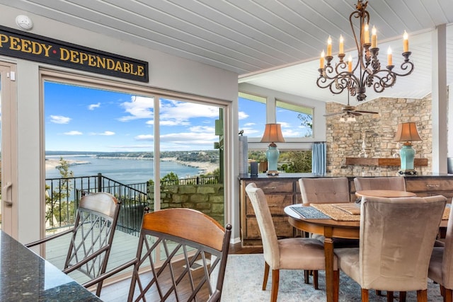 dining room featuring a water view, wood finished floors, and wooden ceiling
