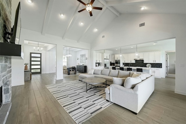 1635 Nature View Loop, Driftwood, TX 78619 - living area featuring beamed ceiling, ceiling fan, high vaulted ceiling, a chandelier, and light wood-style floors