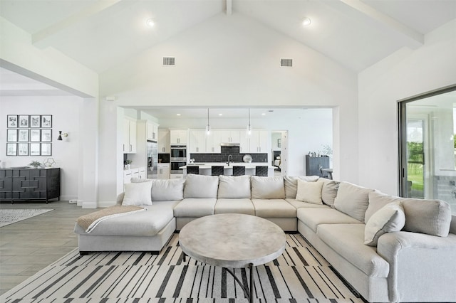 1635 Nature View Loop, Driftwood, TX 78619 - living area featuring beamed ceiling, high vaulted ceiling, recessed lighting, baseboards, and light wood-type flooring