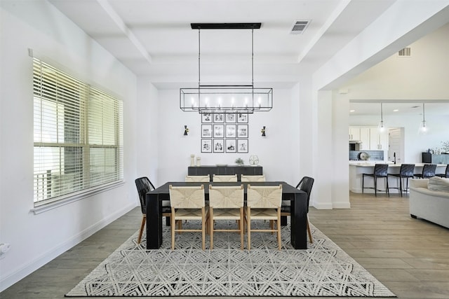 1635 Nature View Loop, Driftwood, TX 78619 - dining space featuring a chandelier, wood finished floors, and a raised ceiling