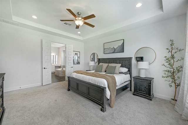 1635 Nature View Loop, Driftwood, TX 78619 - carpeted bedroom featuring a tray ceiling, recessed lighting, ensuite bath, a ceiling fan, and baseboards