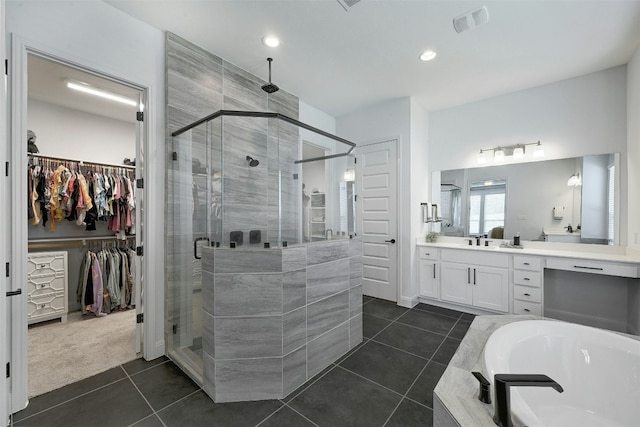 1635 Nature View Loop, Driftwood, TX 78619 - bathroom with a stall shower, vanity, a bath, a walk in closet, and tile patterned flooring