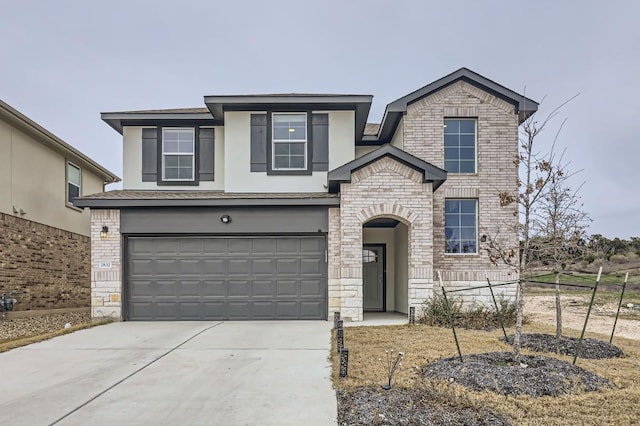 view of front of home featuring brick siding, concrete driveway, stone siding, an attached garage, and stucco siding