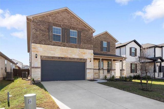 traditional-style house with central AC unit, an attached garage, brick siding, driveway, and stone siding