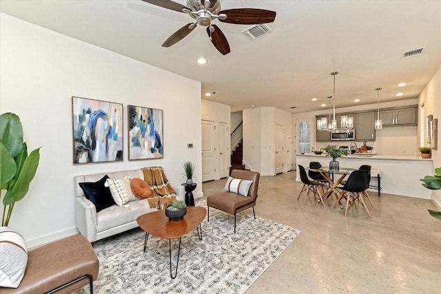 1912 Bunche Rd Unit B, Austin, TX 78721 - living area with recessed lighting, stairway, concrete floors, a ceiling fan, and a chandelier
