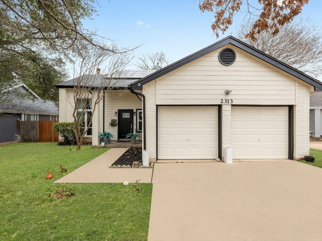 view of front of property with a garage, concrete driveway, a chimney, a front lawn, and brick siding