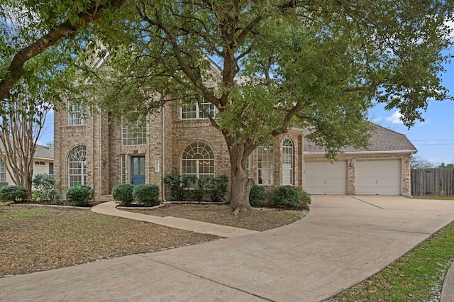 view of front facade featuring a garage, brick siding, and driveway