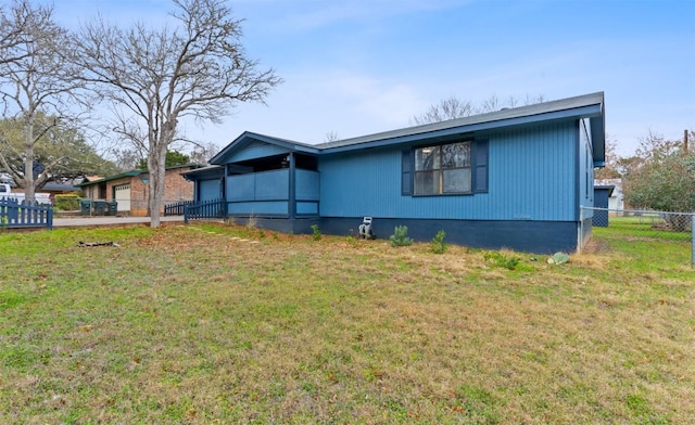 exterior space with a garage, fence, and a front lawn