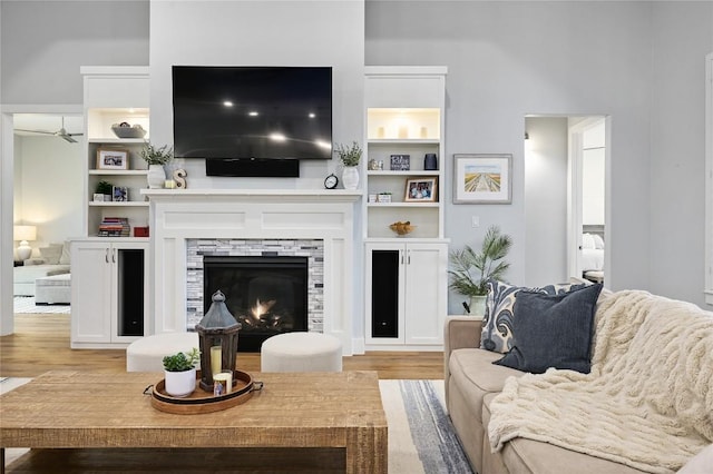 233 Lakefront Dr, Lago Vista, TX 78645 - living area with built in features, light wood finished floors, and a warm lit fireplace