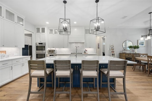 233 Lakefront Dr, Lago Vista, TX 78645 - kitchen featuring light countertops, a chandelier, appliances with stainless steel finishes, and tasteful backsplash
