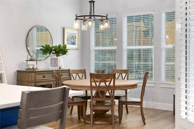 233 Lakefront Dr, Lago Vista, TX 78645 - dining area with light wood finished floors and a chandelier
