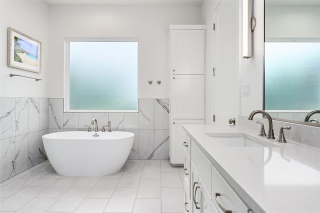 233 Lakefront Dr, Lago Vista, TX 78645 - full bathroom with a freestanding tub, a wainscoted wall, vanity, and tile walls