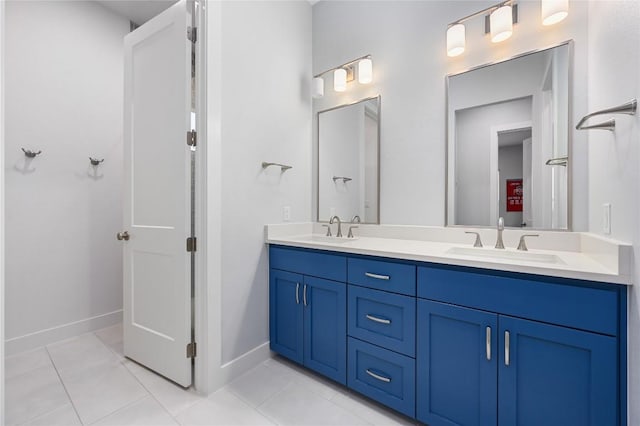 233 Lakefront Dr, Lago Vista, TX 78645 - bathroom featuring double vanity, baseboards, a sink, and tile patterned flooring