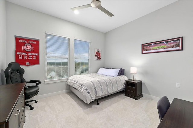 bedroom featuring light carpet, ceiling fan, and baseboards