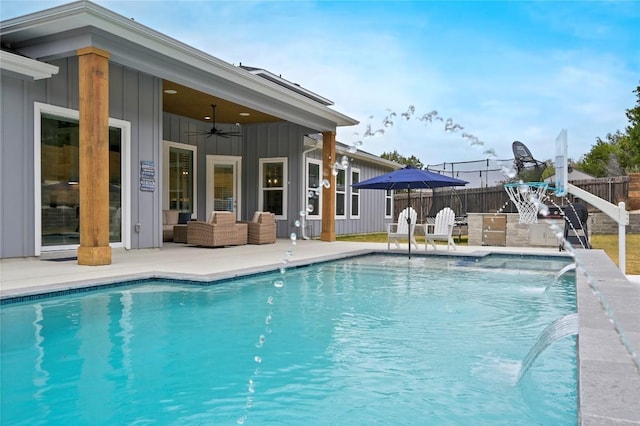 view of swimming pool featuring ceiling fan, fence, and a fenced in pool