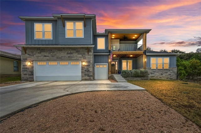 233 Lakefront Dr, Lago Vista, TX 78645 - contemporary home with a balcony, board and batten siding, stone siding, driveway, and an attached garage