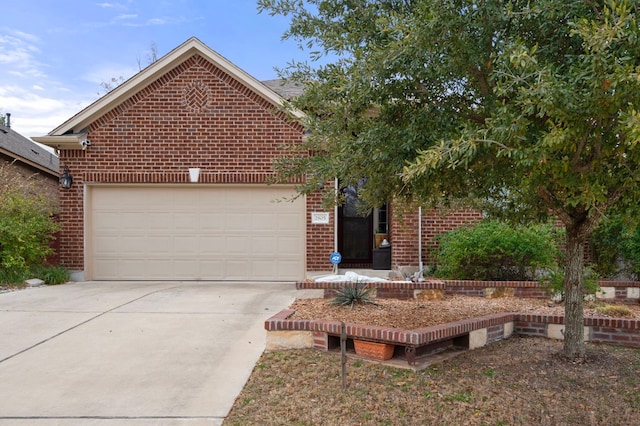 view of front of property with an attached garage, concrete driveway, and brick siding