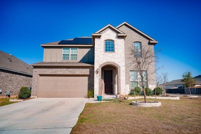 5864 Bianca Dr, Round Rock, TX 78665 - french country style house with solar panels, driveway, a garage, a front yard, and board and batten siding