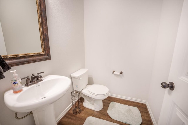 5864 Bianca Dr, Round Rock, TX 78665 - bathroom with wood finished floors, baseboards, toilet, and a sink